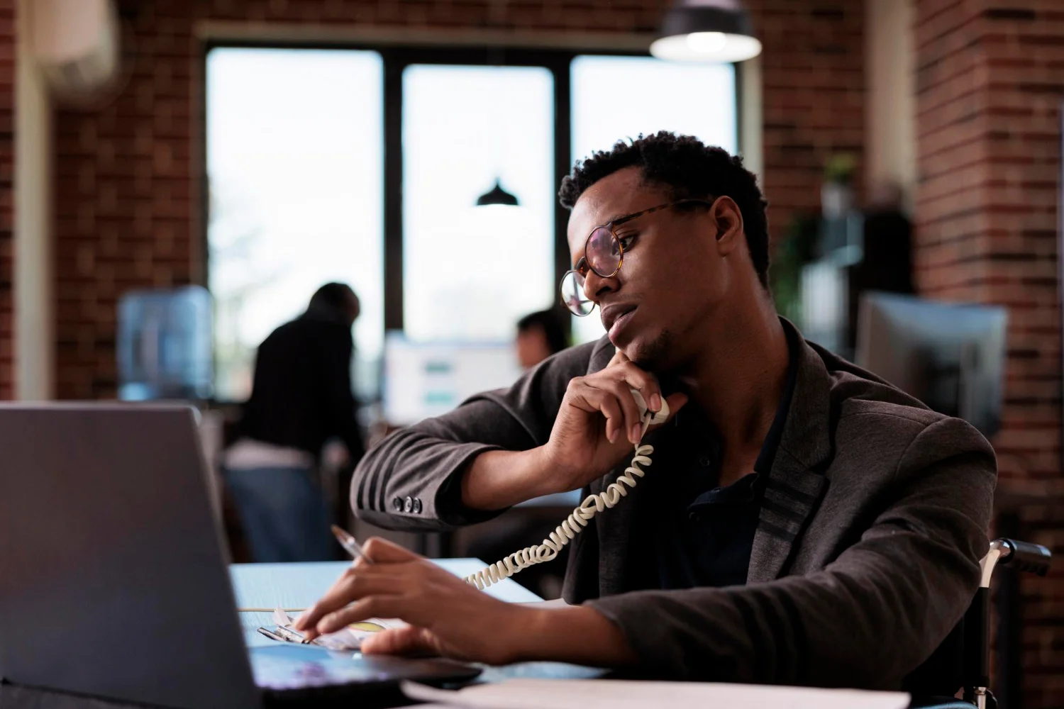 A Eco Call agent taking a call in a loft-style office