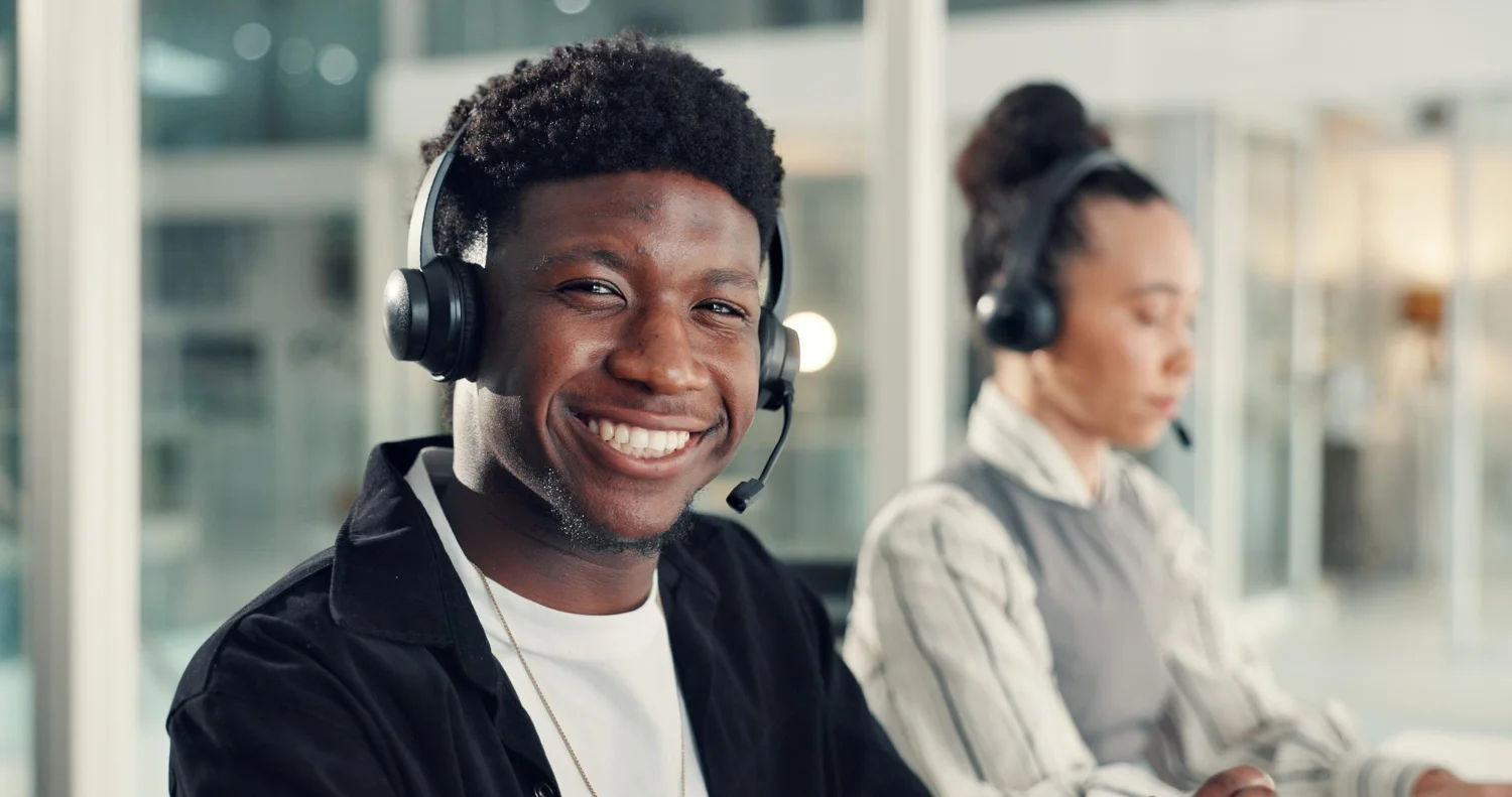 A smiling Eco Call agent wearing a headset